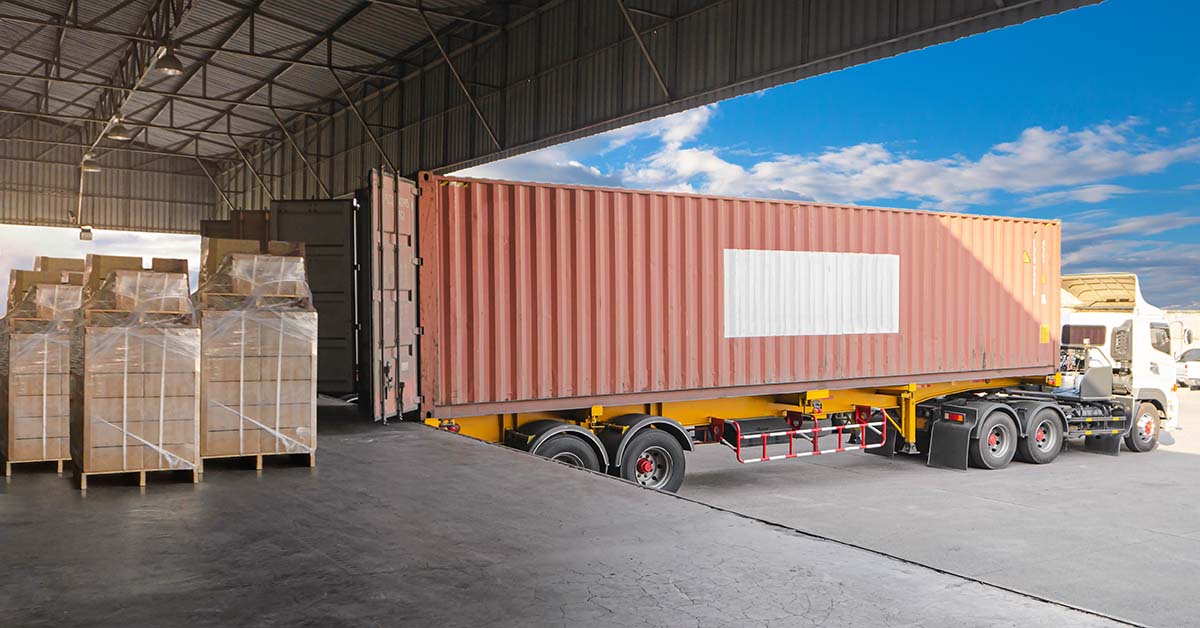 pallets being received from a shipping container on a loading dock